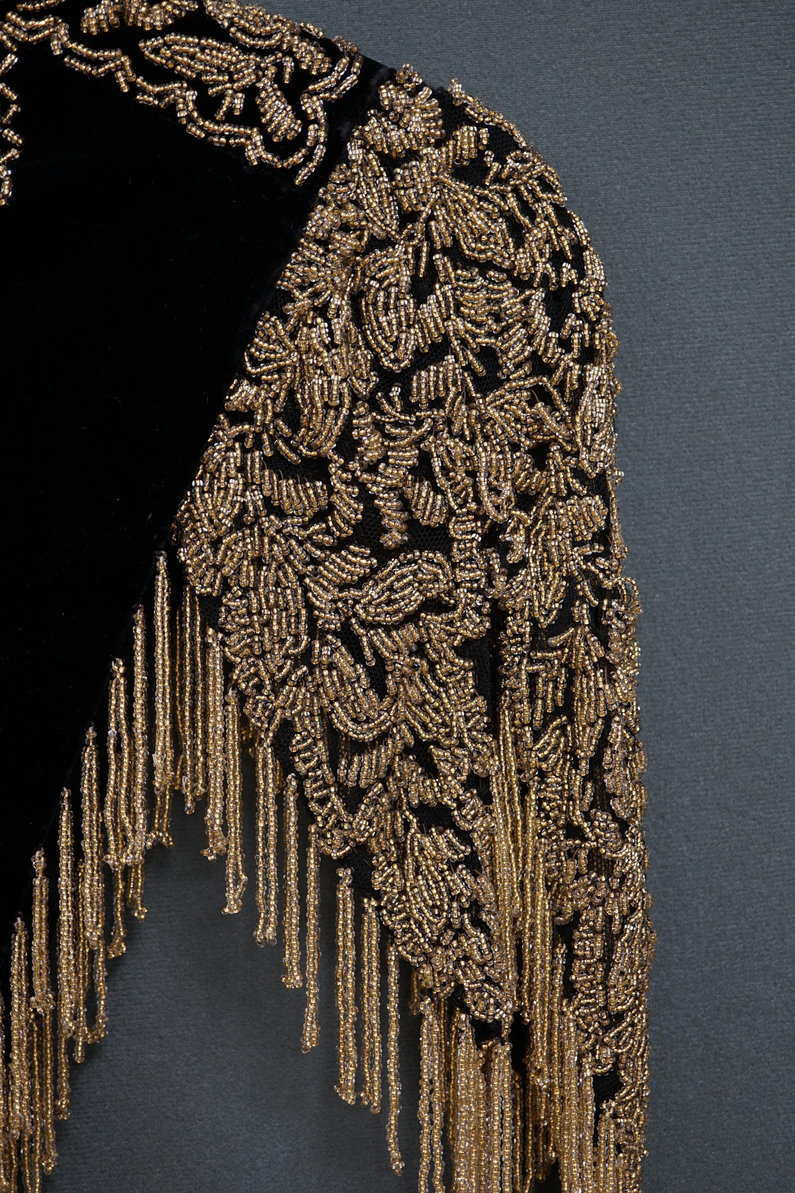 An Edwardian French black velvet and elaborately beaded evening over collar, with makers label, ‘Fillet’, designed with a high collar, front and back panels, all heavily bead worked in an intricate floral design, attache